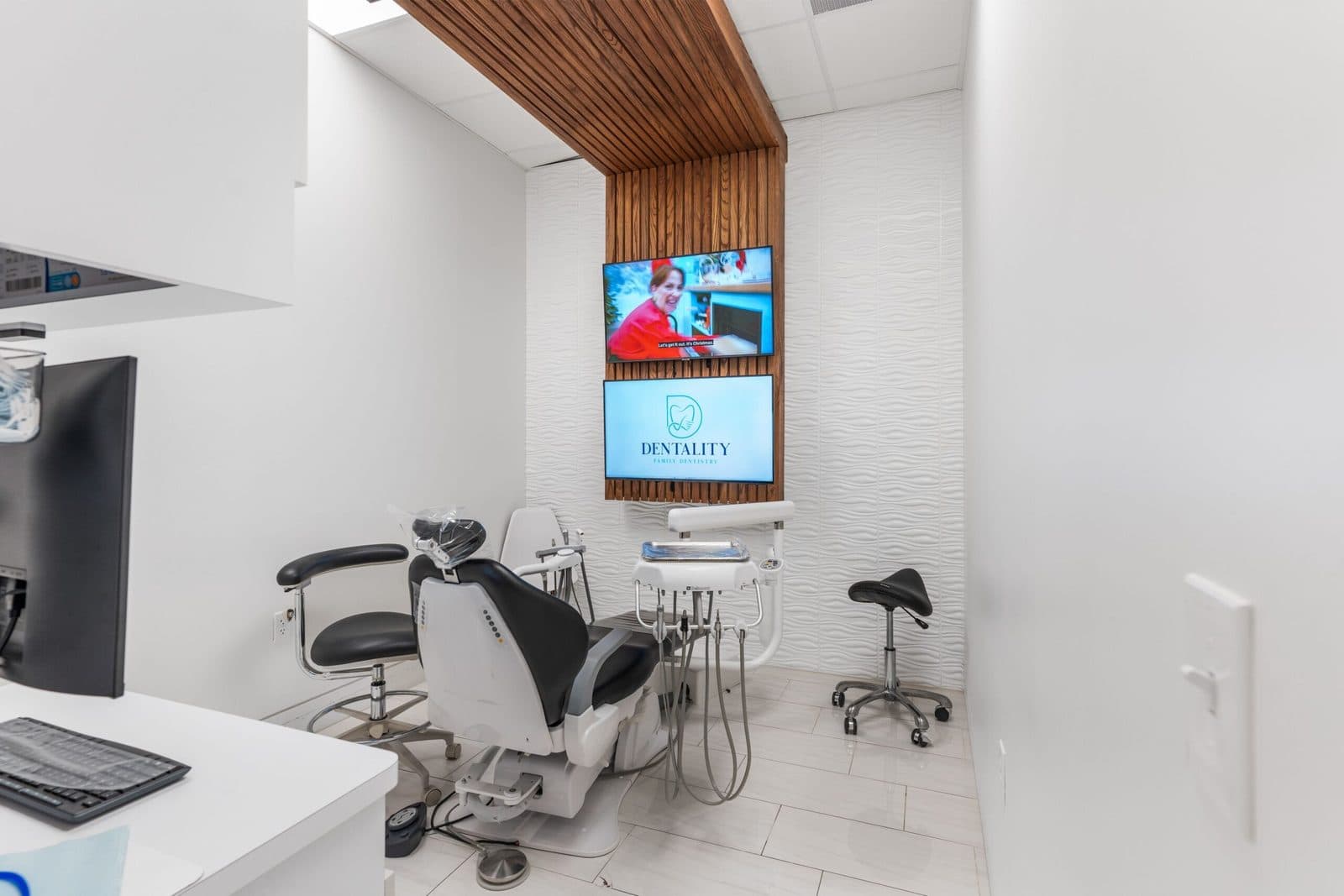 Modern operatory with a ceiling-mounted TV at Dentality Family Dentistry